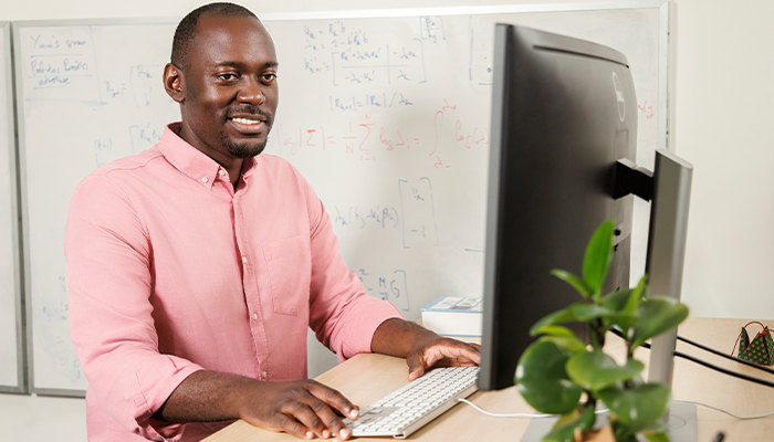 Associate Professor Loic Yengo at his desk