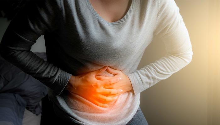 Woman in pain holding abdomen