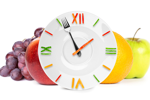 Fruit and clock representing eating regular meals