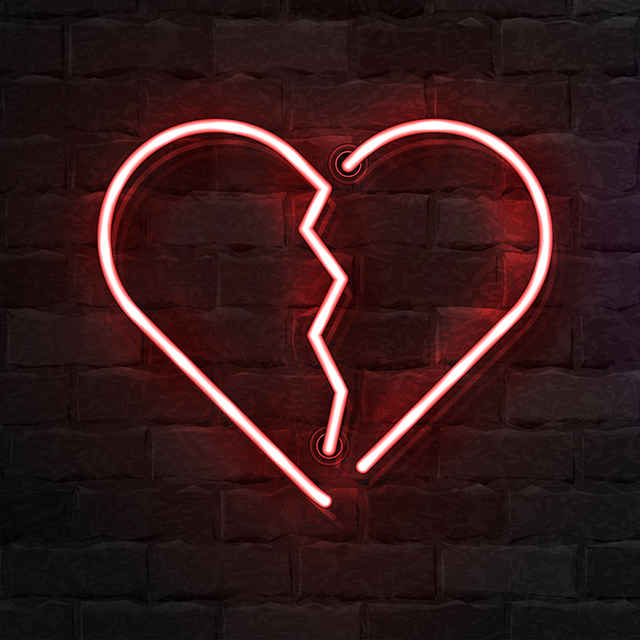 A neon sign of a broken heart