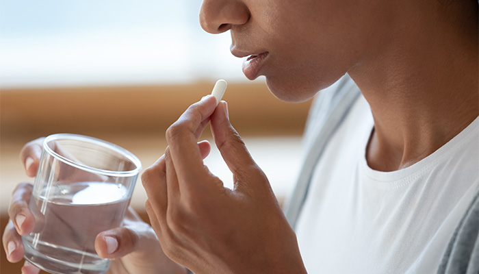 Women taking a pill