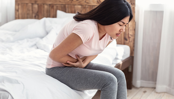 lady doubled over with pain clutching stomach