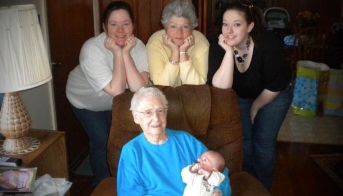 Laura with her family posing in a living room