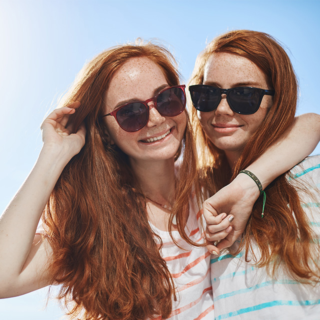 Smiling red haired woman twins