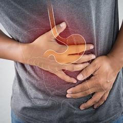 Torso of man holding stomach