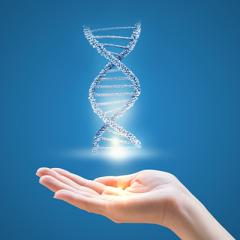 DNA helix floating above palm of woman's open palm