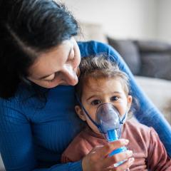 Mother holding child with cystic fibrosis