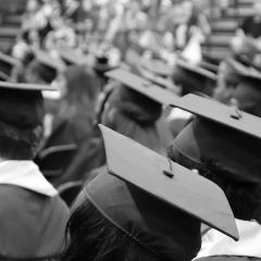 University graduates with caps and gowns - researchers have found that the length of your formal education is linked to your genes.