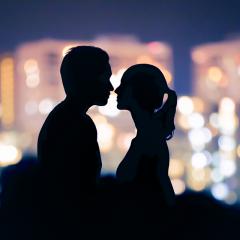 Man and woman in silhouette about to kiss