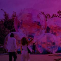 People viewing Ephemeral, an artwork of giant bubbles